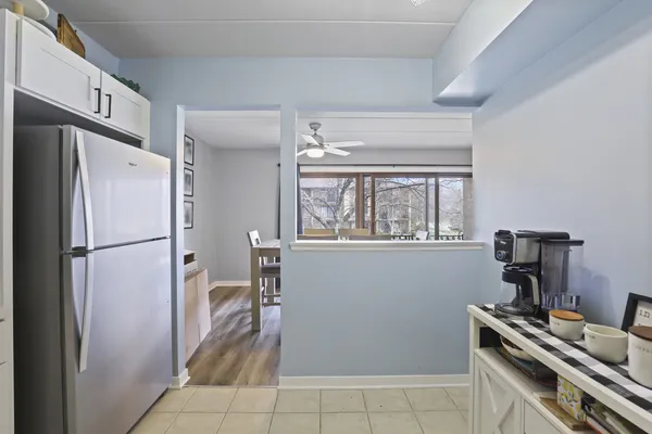 a kitchen with a refrigerator and a stove top oven