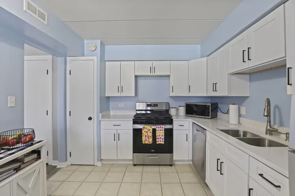 a kitchen with cabinets and appliances