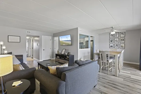 a living room with furniture and wooden floor