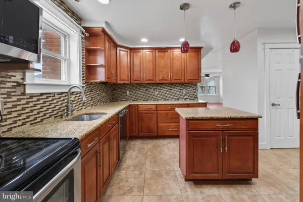 a kitchen with a sink stove and cabinets