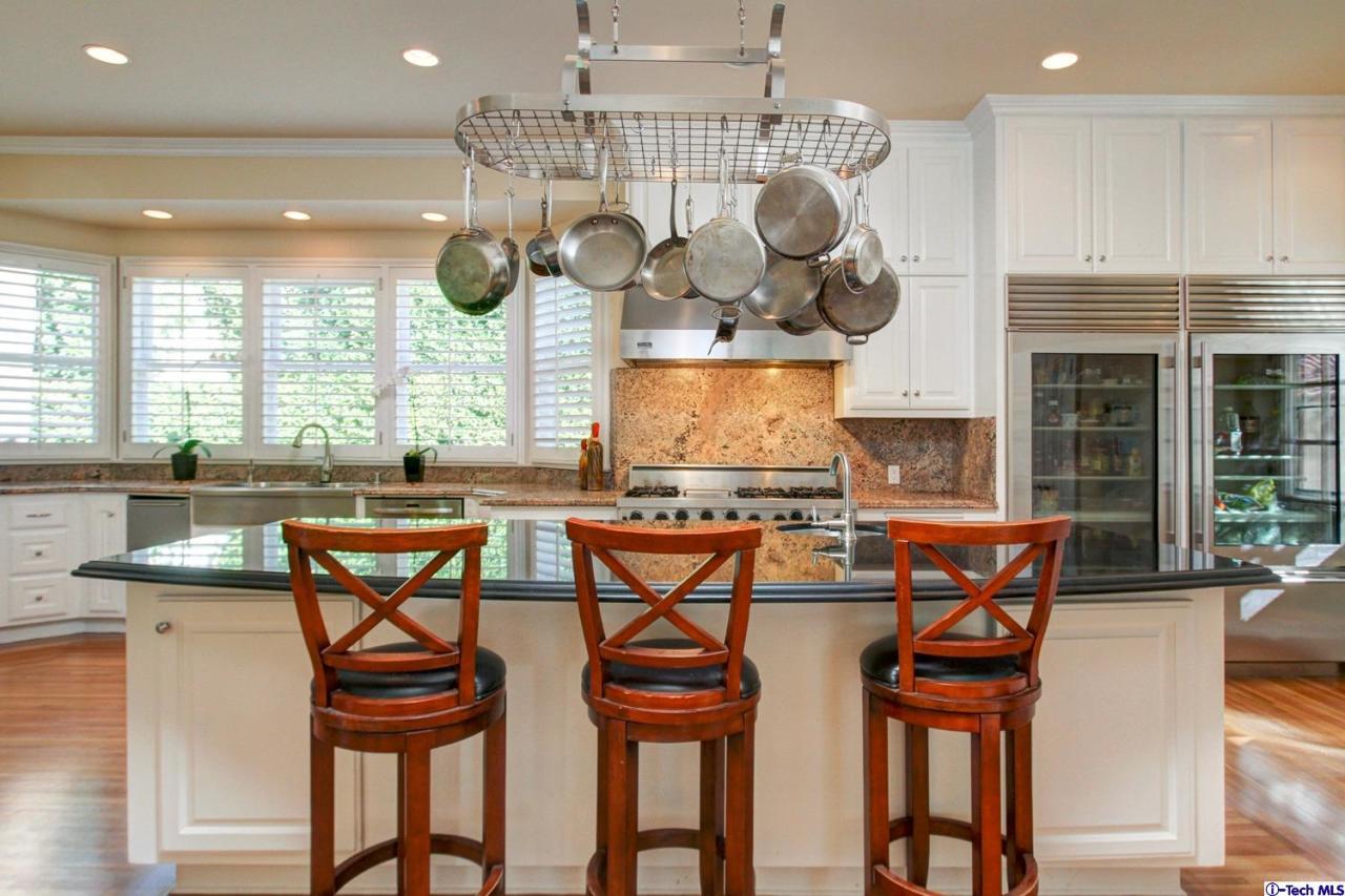 1680 Lombardy Road Pasadena, CA 91106 - Photo 19 of 71 a kitchen with stainless steel appliances granite countertop a sink a stove and chairs