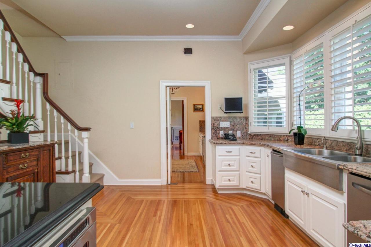 1680 Lombardy Road Pasadena, CA 91106 - Photo 20 of 71 a kitchen with wooden floors and white cabinets