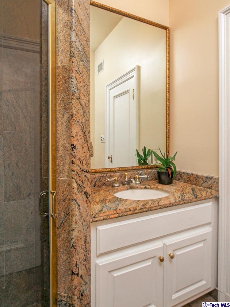 1680 Lombardy Road Pasadena, CA 91106 - Photo 28 of 71 a bathroom with a granite countertop sink and a mirror