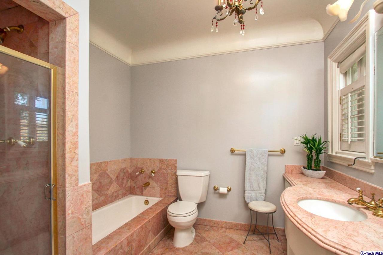 1680 Lombardy Road Pasadena, CA 91106 - Photo 38 of 71 a white toilet sitting next to a bathroom sink