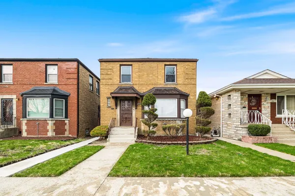 a front view of a house with a garden and porch