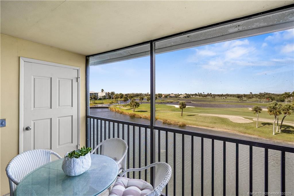 a view of a balcony with chair and city view