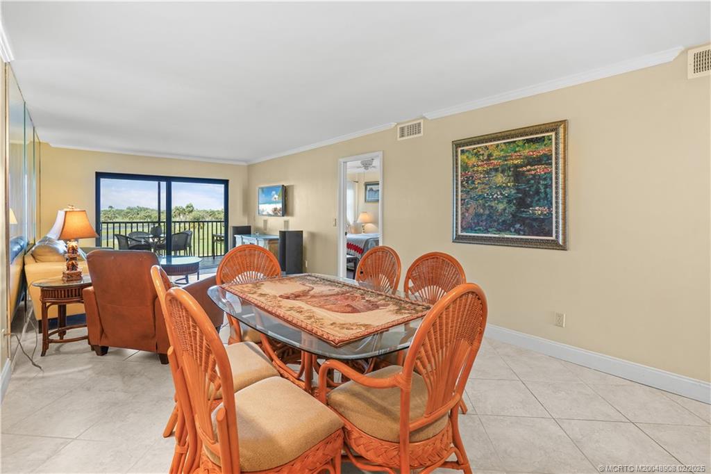 40 Northeast Plantation Road, Unit 415 Stuart, FL 34996 - Photo 11 of 32 a dining room with furniture a livingroom view and a large window