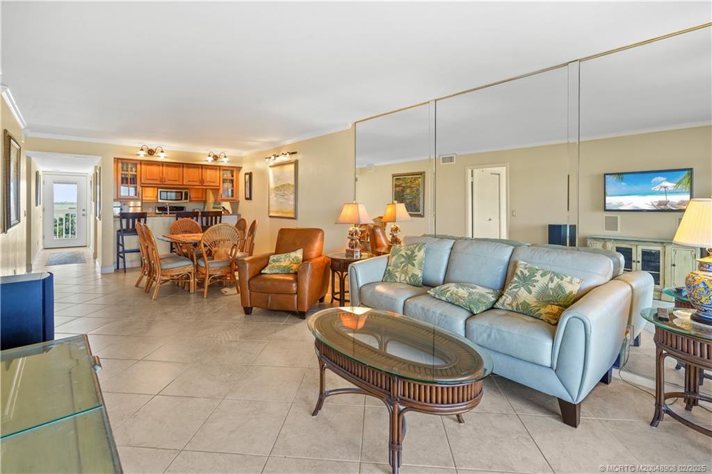 40 Northeast Plantation Road, Unit 415 Stuart, FL 34996 - Photo 13 of 32 a living room with furniture and a flat screen tv