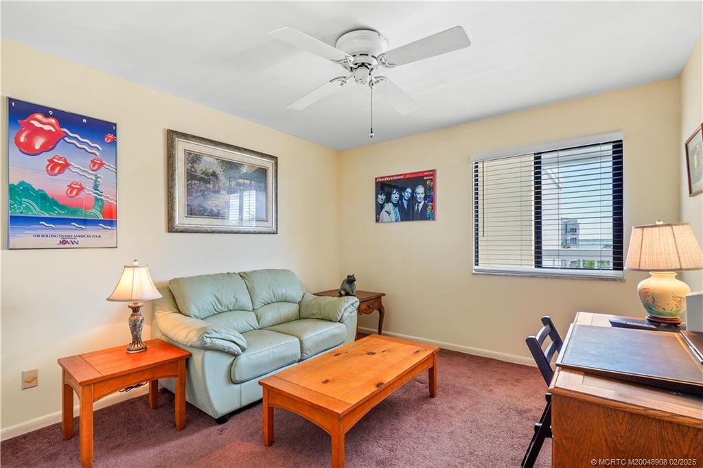 40 Northeast Plantation Road, Unit 415 Stuart, FL 34996 - Photo 19 of 32 a living room with furniture and a window