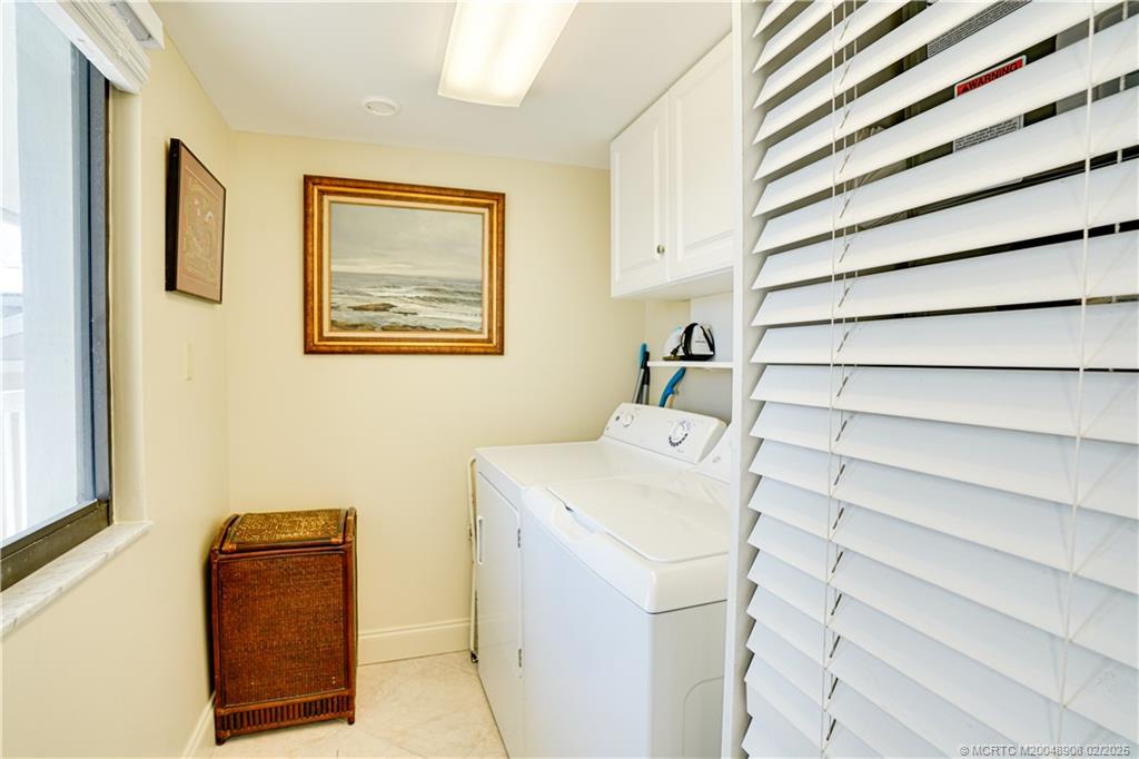 40 Northeast Plantation Road, Unit 415 Stuart, FL 34996 - Photo 22 of 32 a utility room with a washer and dryer