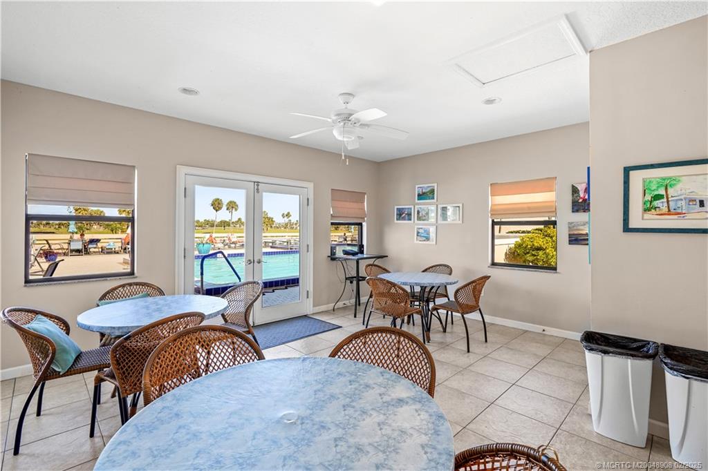 40 Northeast Plantation Road, Unit 415 Stuart, FL 34996 - Photo 26 of 32 a living room with furniture two window and a table