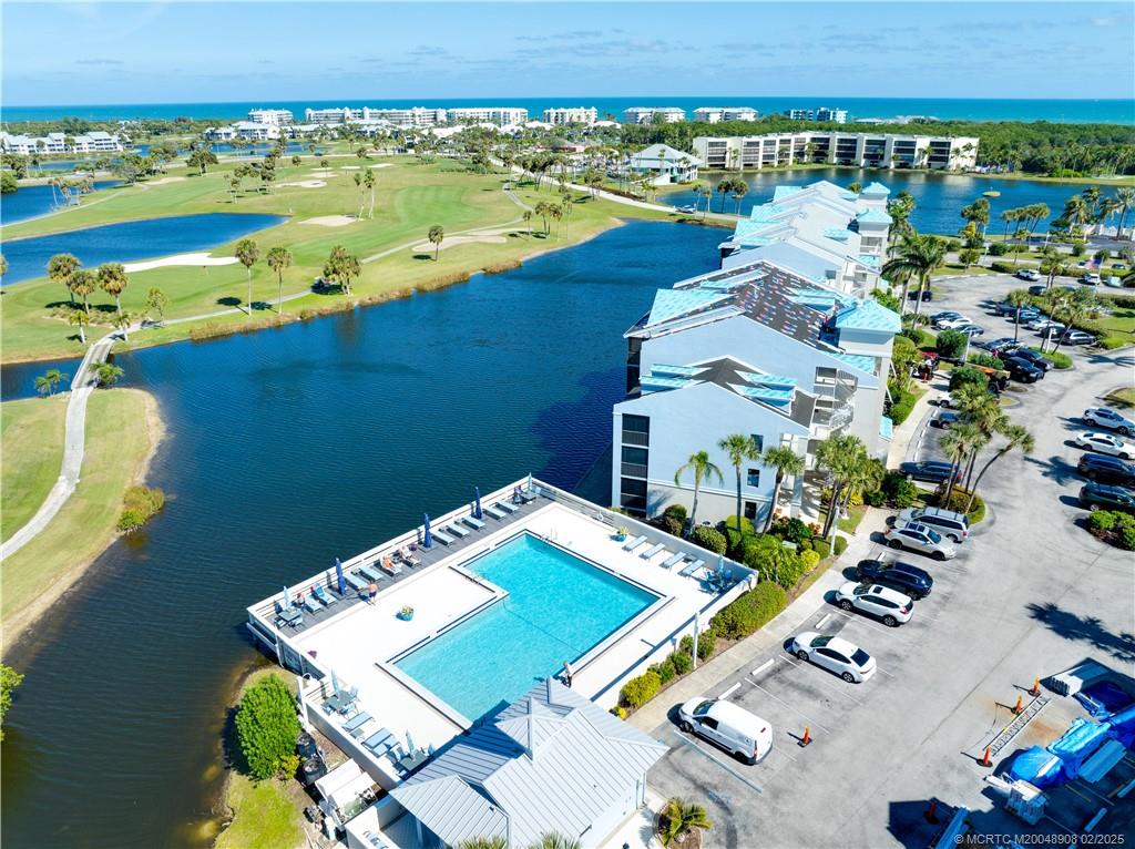 40 Northeast Plantation Road, Unit 415 Stuart, FL 34996 - Photo 30 of 32 an aerial view of a residential apartment building with a swimming pool