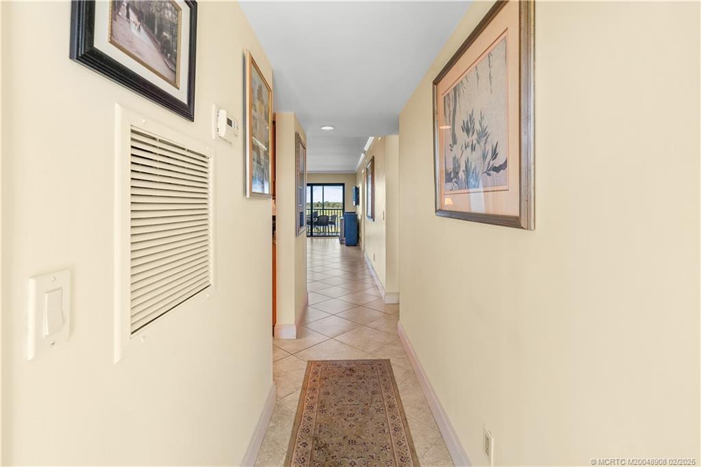 40 Northeast Plantation Road, Unit 415 Stuart, FL 34996 - Photo 10 of 32 a view of a hallway with wooden floor and dining room