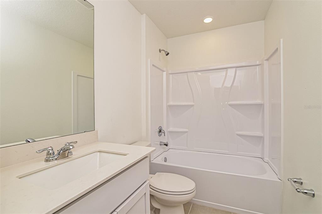 2207 Chris Drive Lake Wales, FL 33859 - Photo 15 of 16 a bathroom with a granite countertop sink a toilet and shower