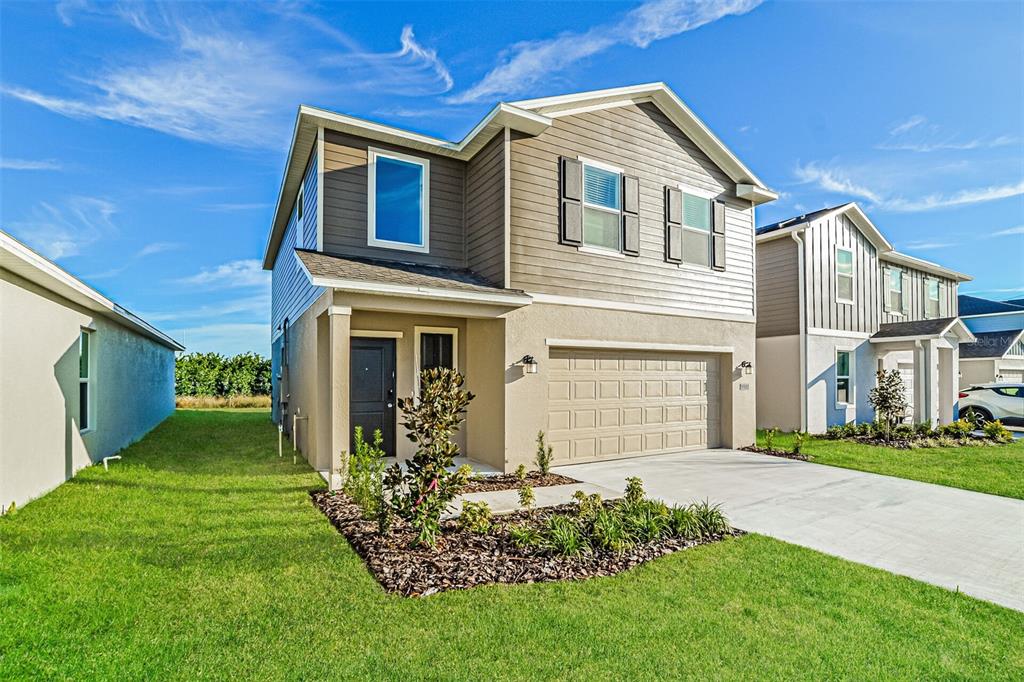 2207 Chris Drive Lake Wales, FL 33859 - Photo 2 of 16 a front view of a house with a yard and garage