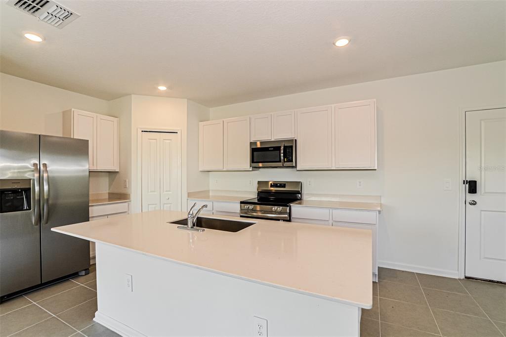 2207 Chris Drive Lake Wales, FL 33859 - Photo 9 of 16 a kitchen with stainless steel appliances a refrigerator stove microwave and sink