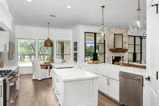 a view of a kitchen with a large window and furniture