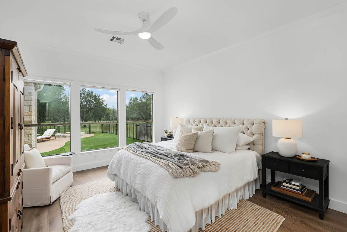 1921 Ruby Ranch Road Buda, TX 78610 - Photo 17 of 36 a bed room with a bed and a large window