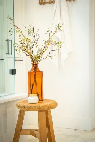 a en suite bathroom with a granite countertop sink and mirror