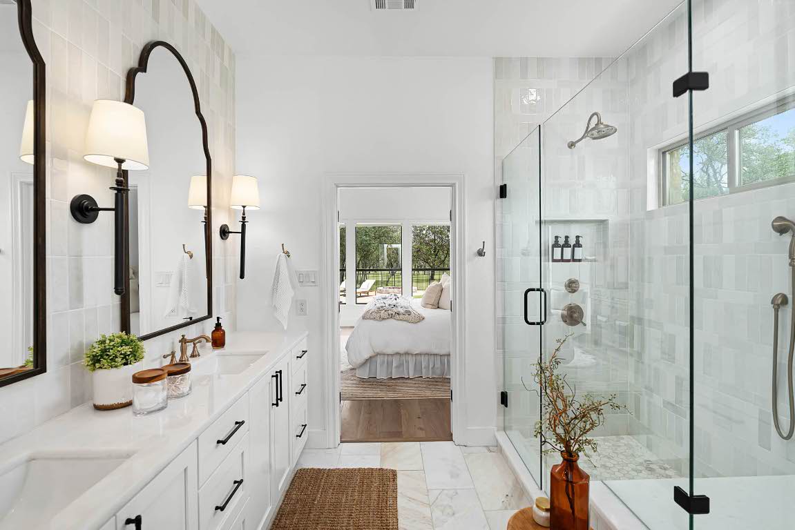 1921 Ruby Ranch Road Buda, TX 78610 - Photo 22 of 36 a bathroom with a double vanity sink and shower