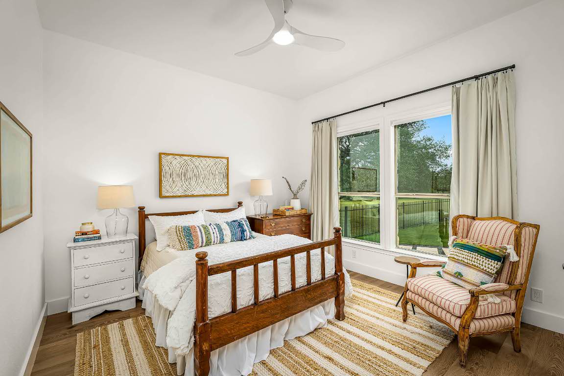 1921 Ruby Ranch Road Buda, TX 78610 - Photo 23 of 36 a bedroom with furniture and a window