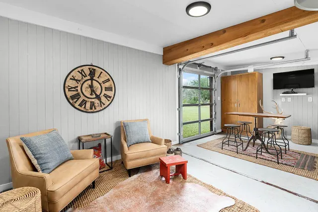 a living room with couches a fireplace and a flat screen tv