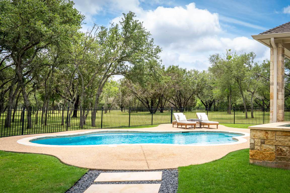 1921 Ruby Ranch Road Buda, TX 78610 - Photo 33 of 36 a view of a park with swings and a tree