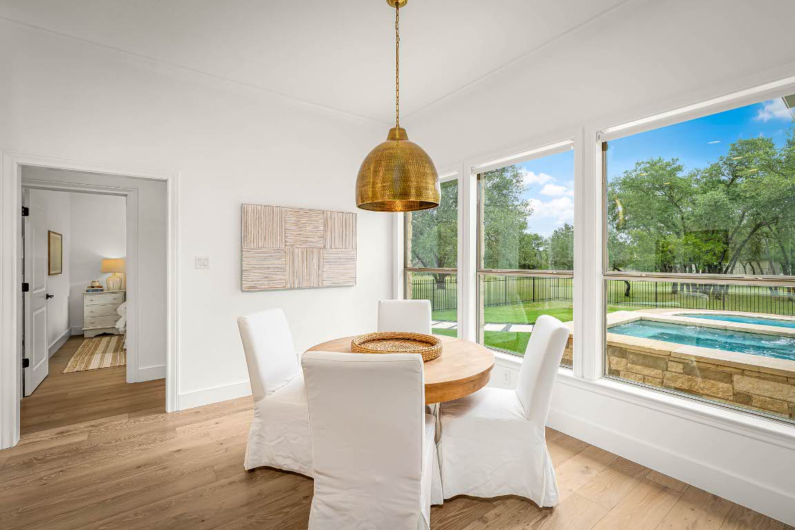 1921 Ruby Ranch Road Buda, TX 78610 - Photo 10 of 36 a view of a dining room with furniture window and wooden floor