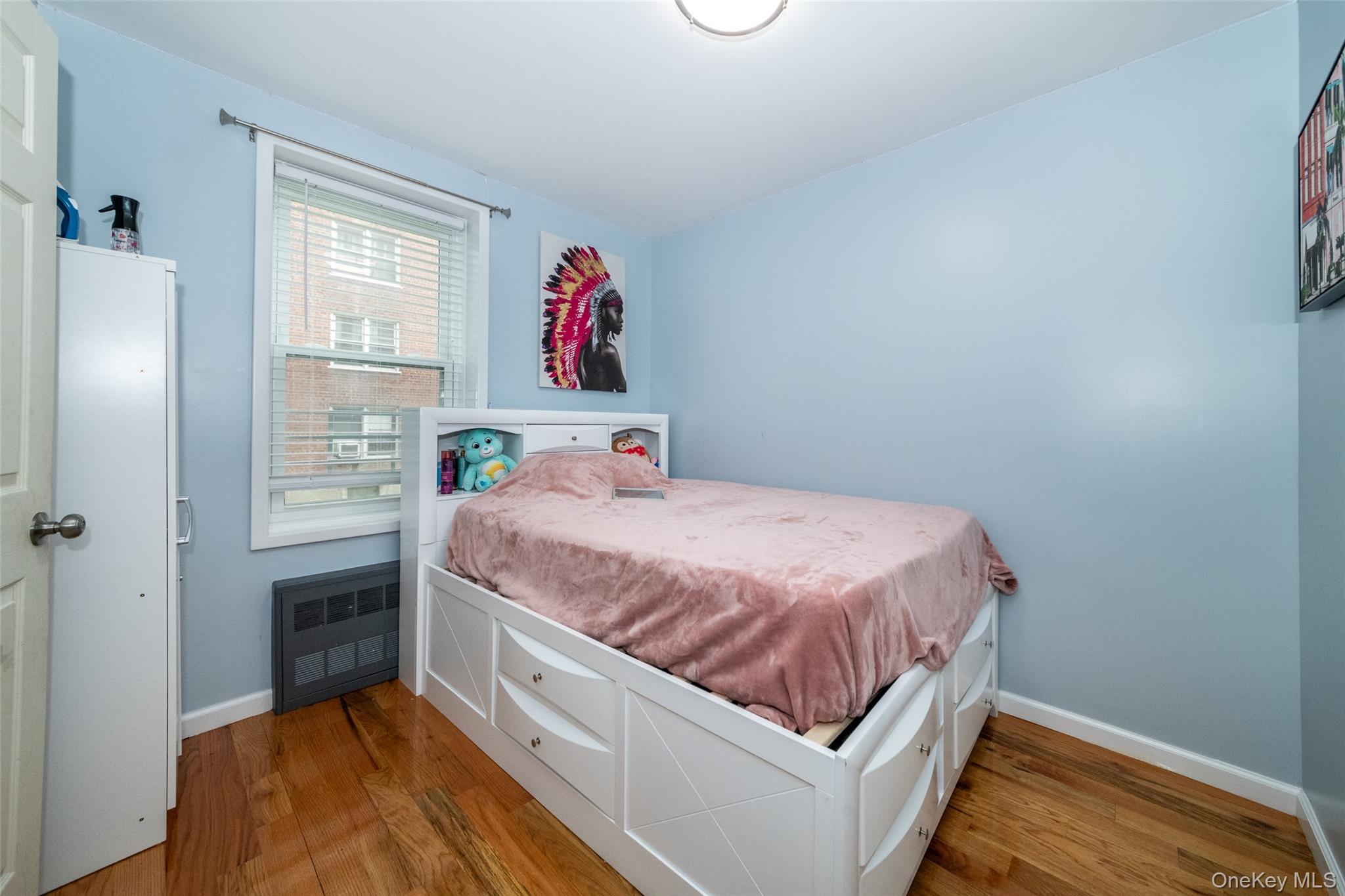 90 Union Street, Unit 1A New Rochelle, NY 10805 - Photo 12 of 28 a bed sitting in a bedroom next to a window