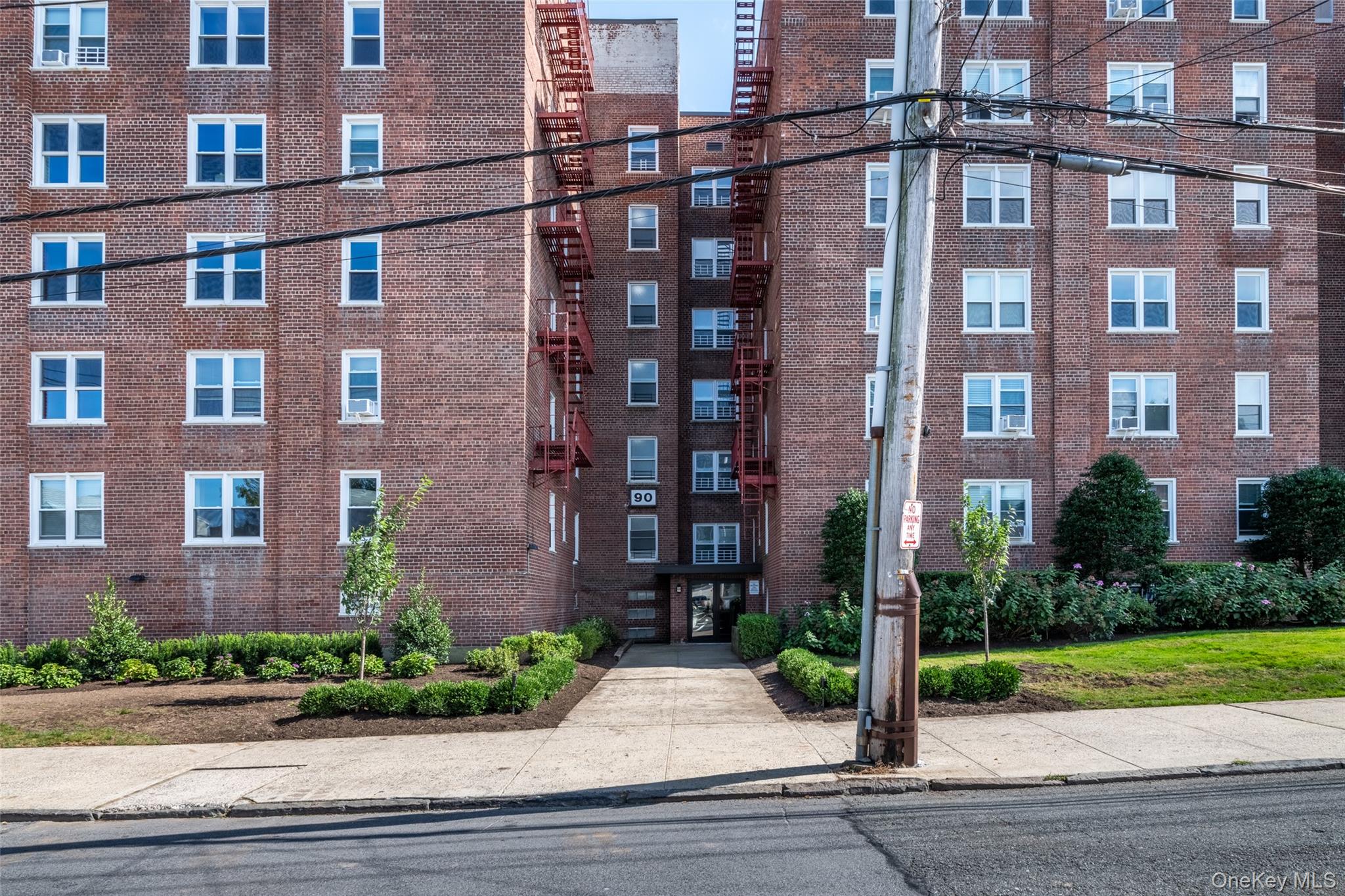 90 Union Street, Unit 1A New Rochelle, NY 10805 - Photo 18 of 28 a view of a brick building next to a yard