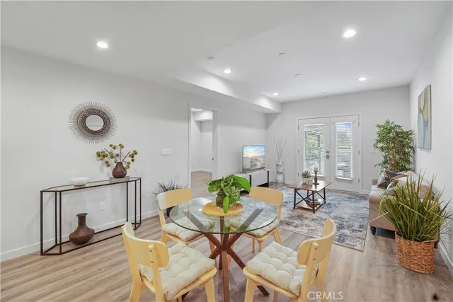 a living room with furniture potted plant and a wooden floor