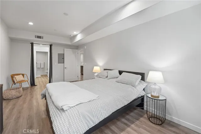 a bathroom with a toilet a sink and a large mirror