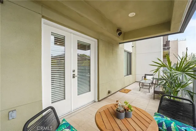 a balcony with furniture and a potted plant