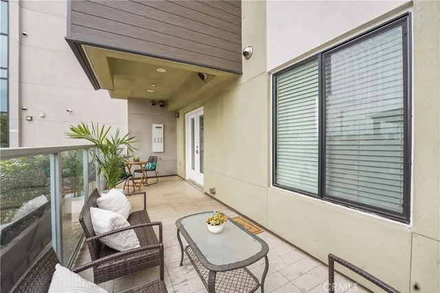 a view of a patio with couches and potted plants