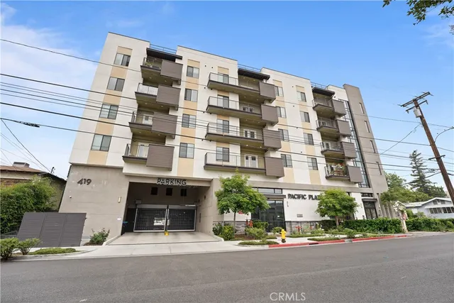 a view of a white house with a garage