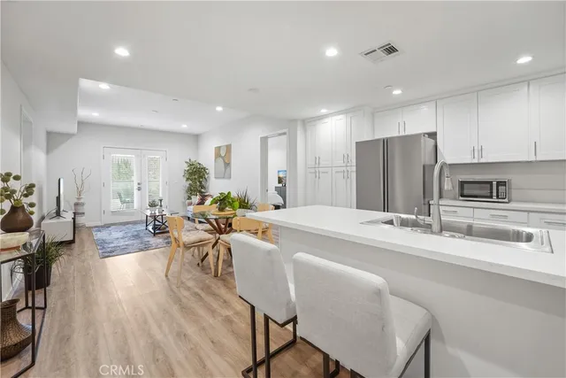 a large kitchen with a table and chairs