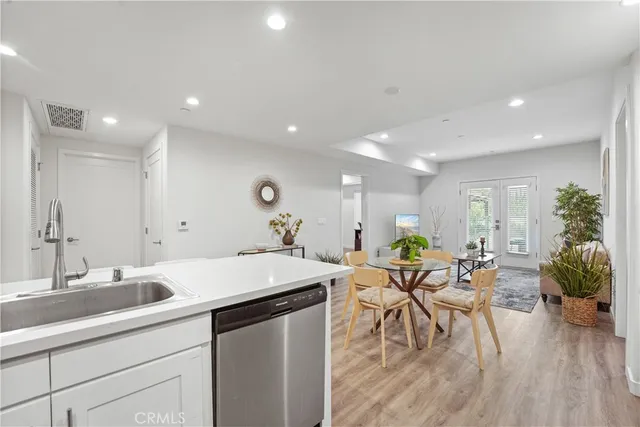a kitchen with stainless steel appliances a refrigerator sink and microwave