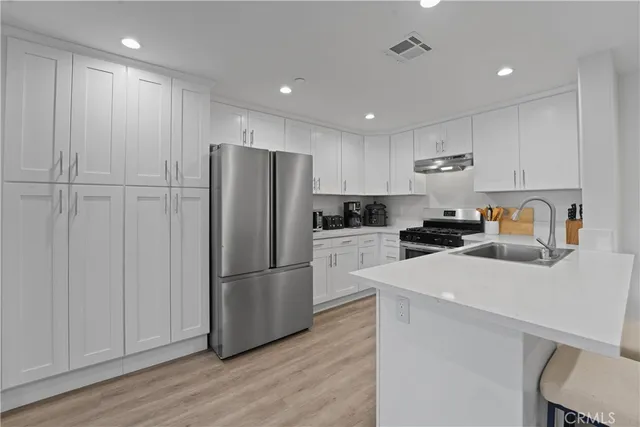 a kitchen with a sink stove and cabinets