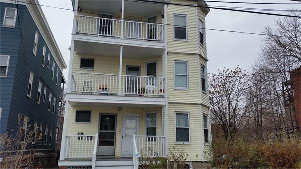 35 Waverly Street, Unit B Boston, MA 02135 - Photo 2 of 13 a view of a brick house with large windows and a tree