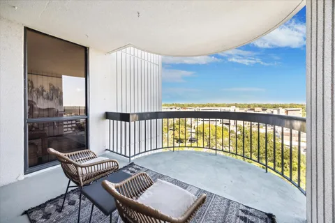 a balcony with table and chairs