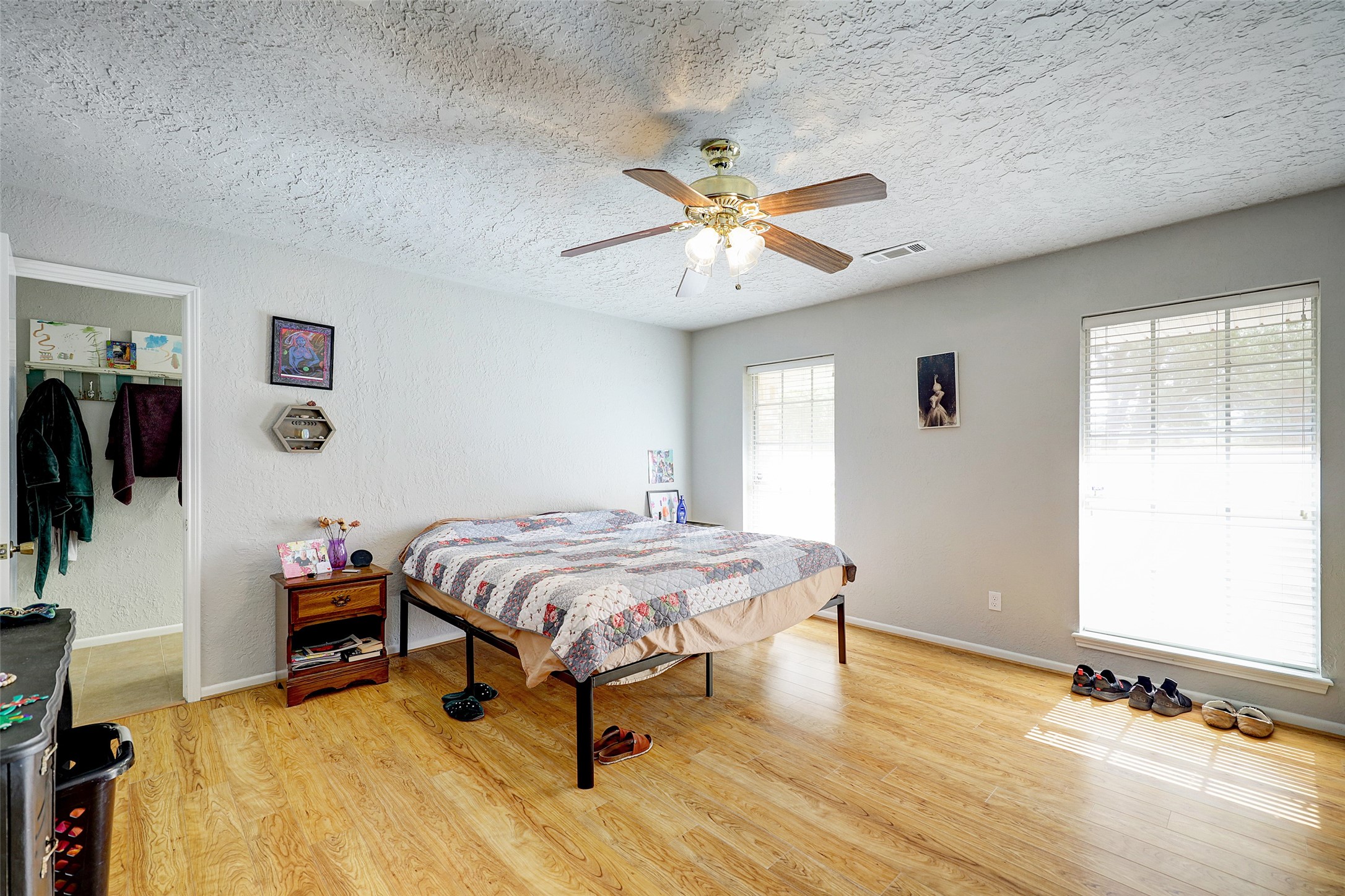 1664 North McCaleb Road Montgomery, TX 77316 - Photo 14 of 23 a bedroom with a bed and a chandelier