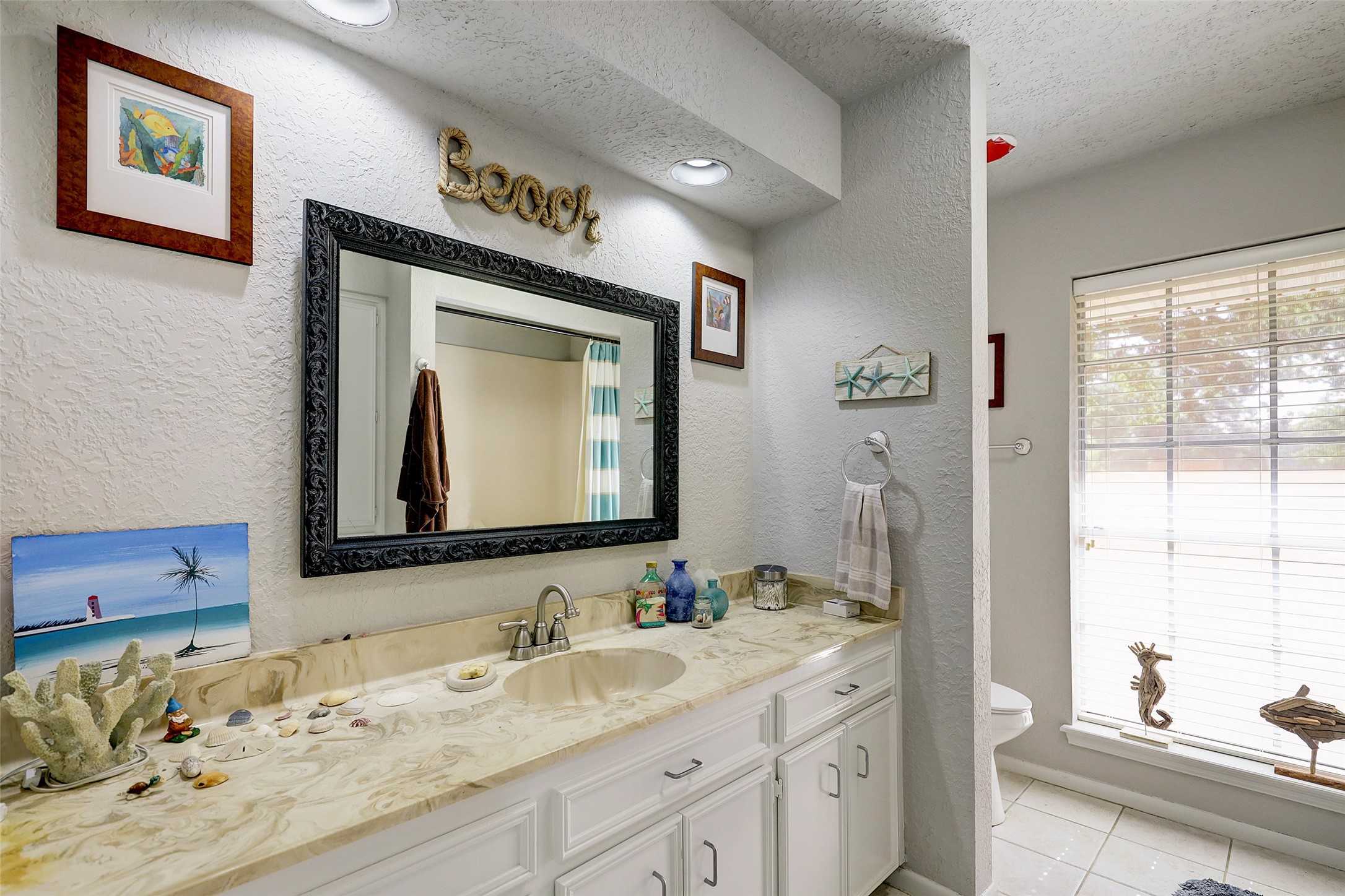 1664 North McCaleb Road Montgomery, TX 77316 - Photo 20 of 23 a bathroom with a granite countertop sink and a mirror