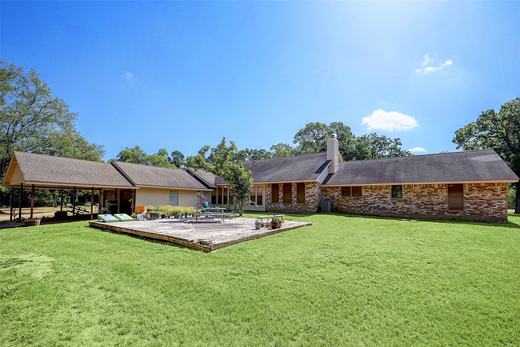 1664 North McCaleb Road Montgomery, TX 77316 - Photo 5 of 23 a front view of a house with a garden and trees