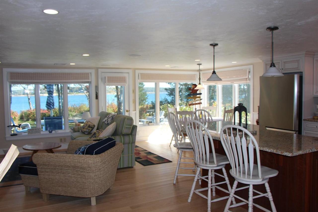 206 Clipper Road Bourne, MA 02532 - Photo 20 of 35 a dining room with furniture a chandelier and wooden floor
