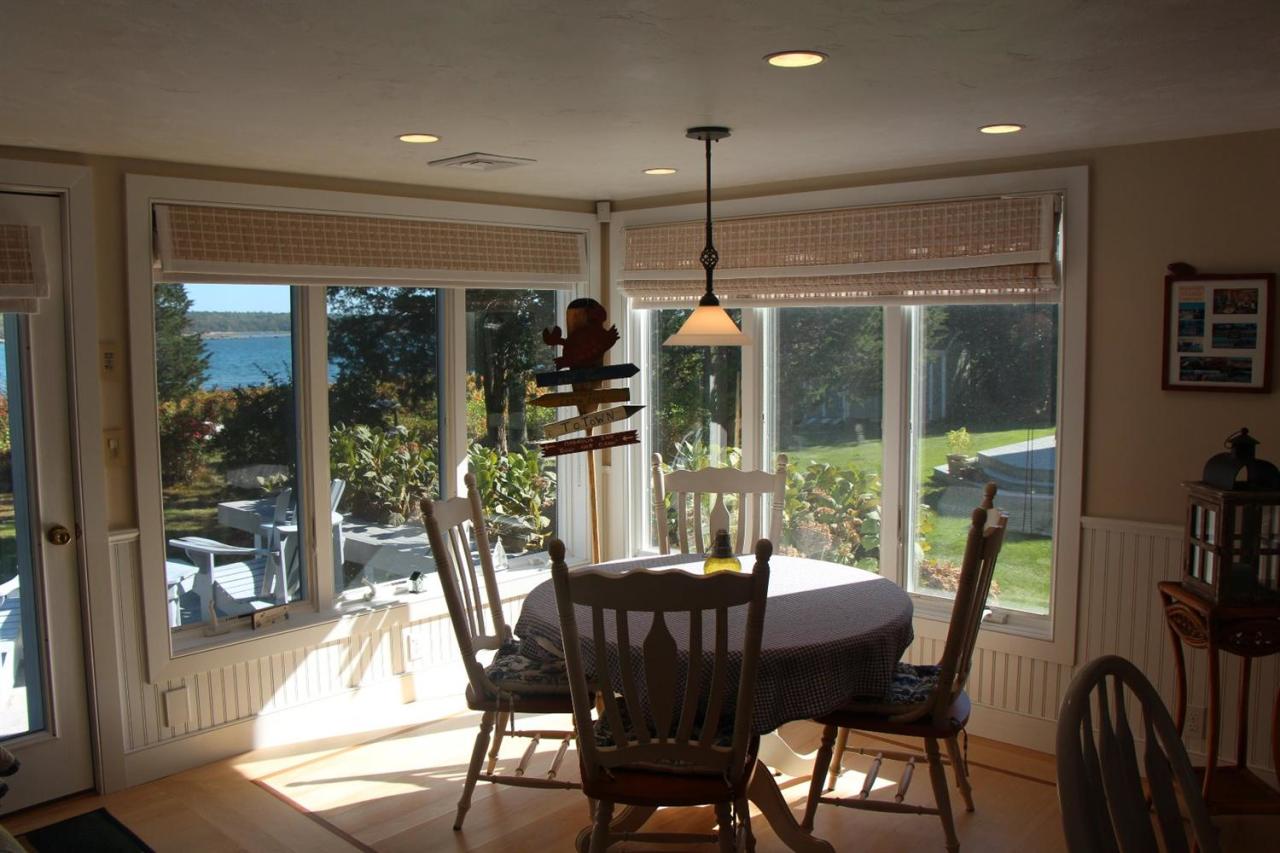 206 Clipper Road Bourne, MA 02532 - Photo 23 of 35 a view of a dining room with furniture wooden floor and a chandelier