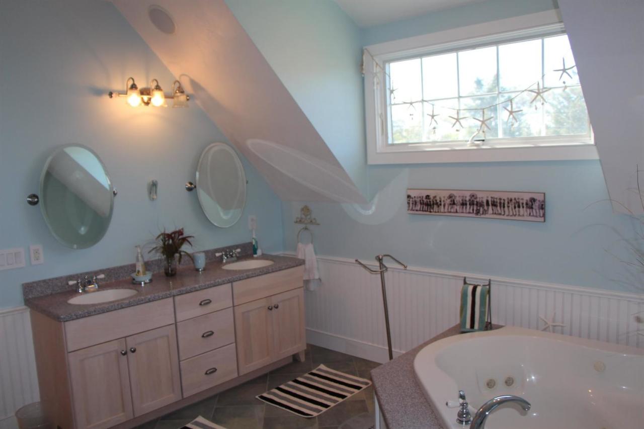 206 Clipper Road Bourne, MA 02532 - Photo 34 of 35 a bathroom with a double vanity sink and a mirror