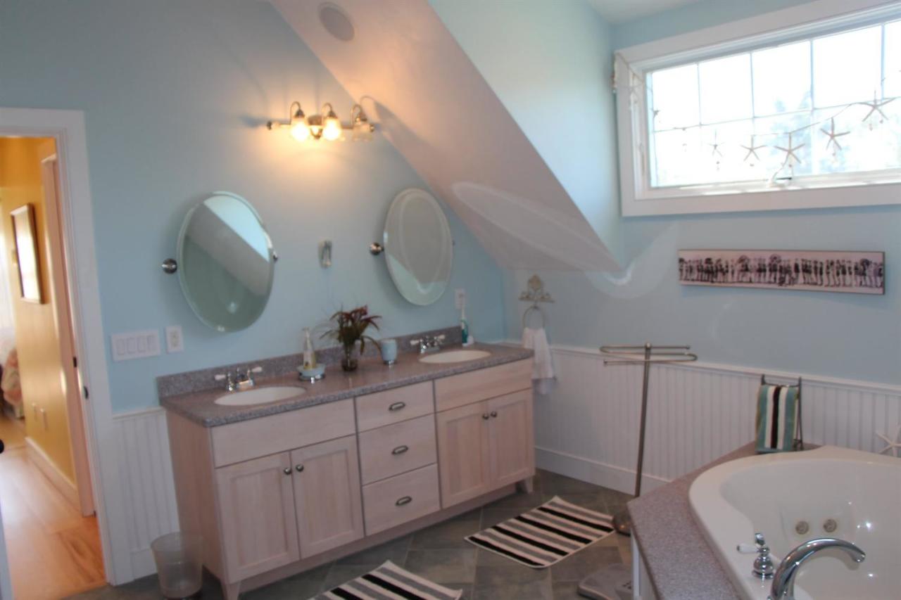 206 Clipper Road Bourne, MA 02532 - Photo 35 of 35 a bathroom with a double vanity sink toilet mirror and window