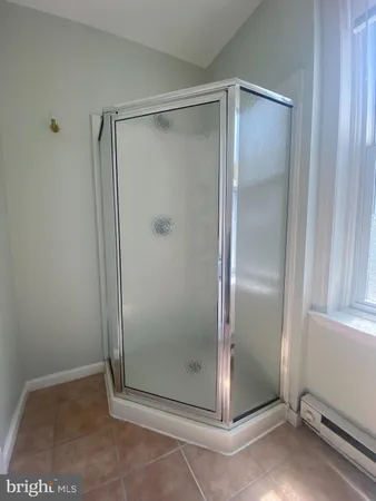 a bathroom with a glass door shower