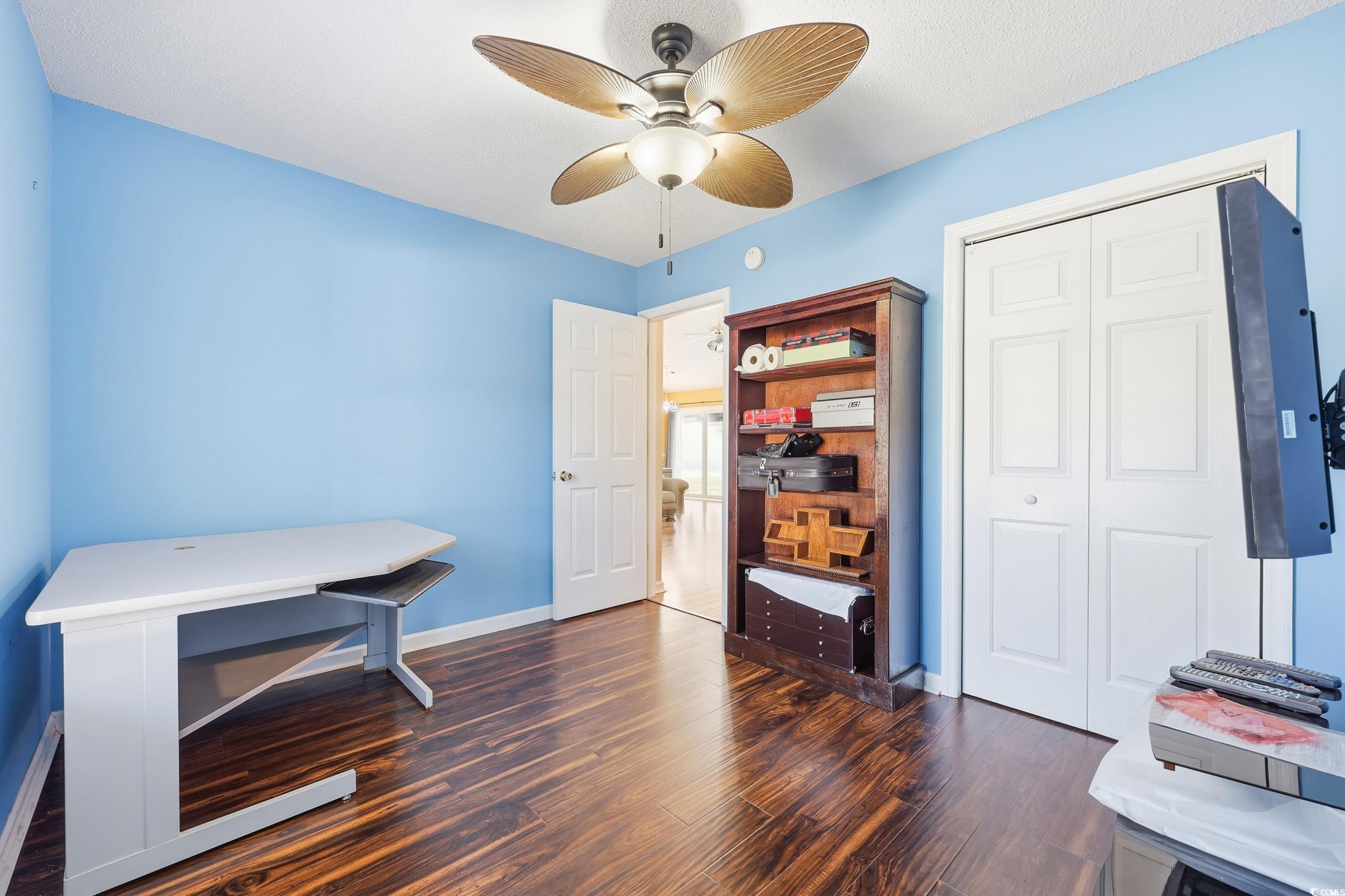 2560 Wild Game Trail Myrtle Beach, SC 29588 - Photo 16 of 24 Bedroom featuring ceiling fan, dark wood-style floors, and a closet