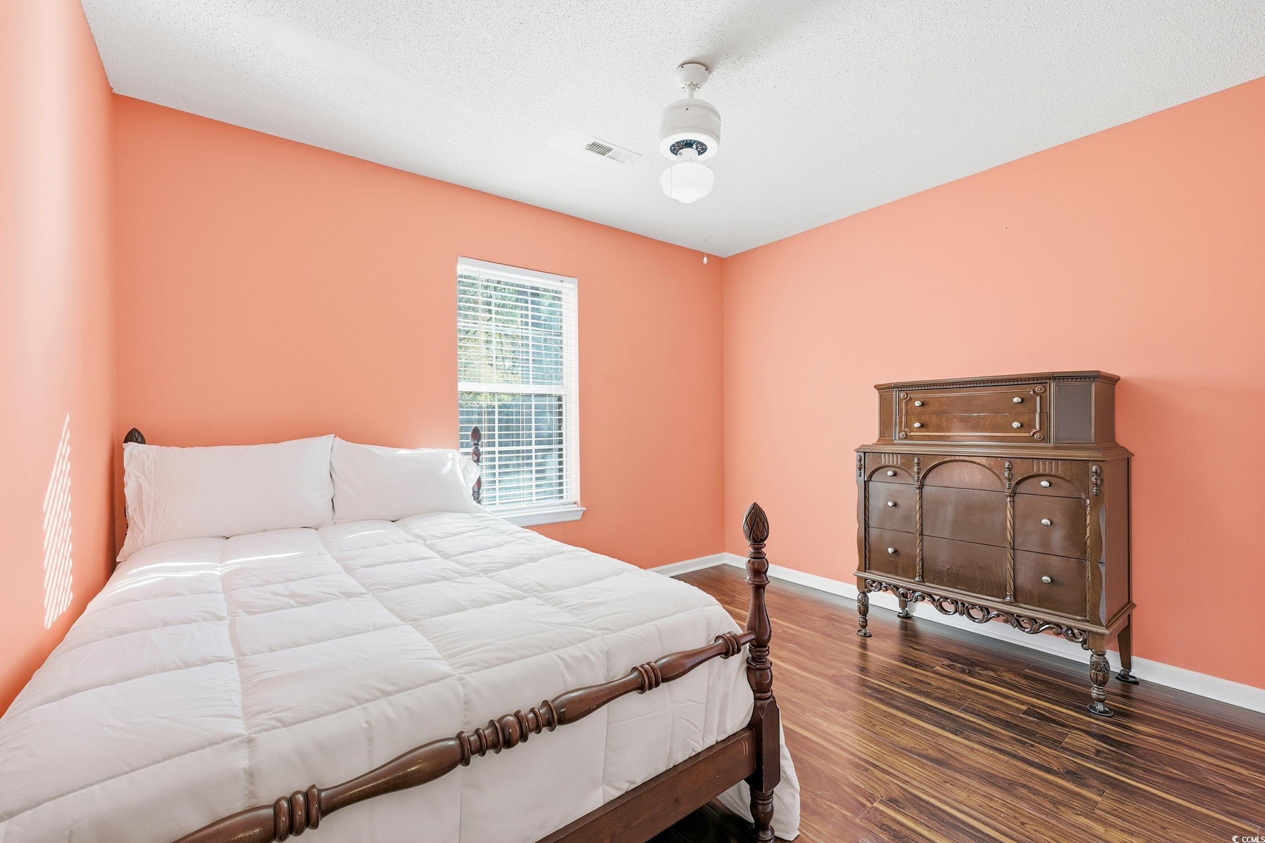 2560 Wild Game Trail Myrtle Beach, SC 29588 - Photo 17 of 24 Bedroom with dark wood-type flooring, a textured ceiling, and ceiling fan